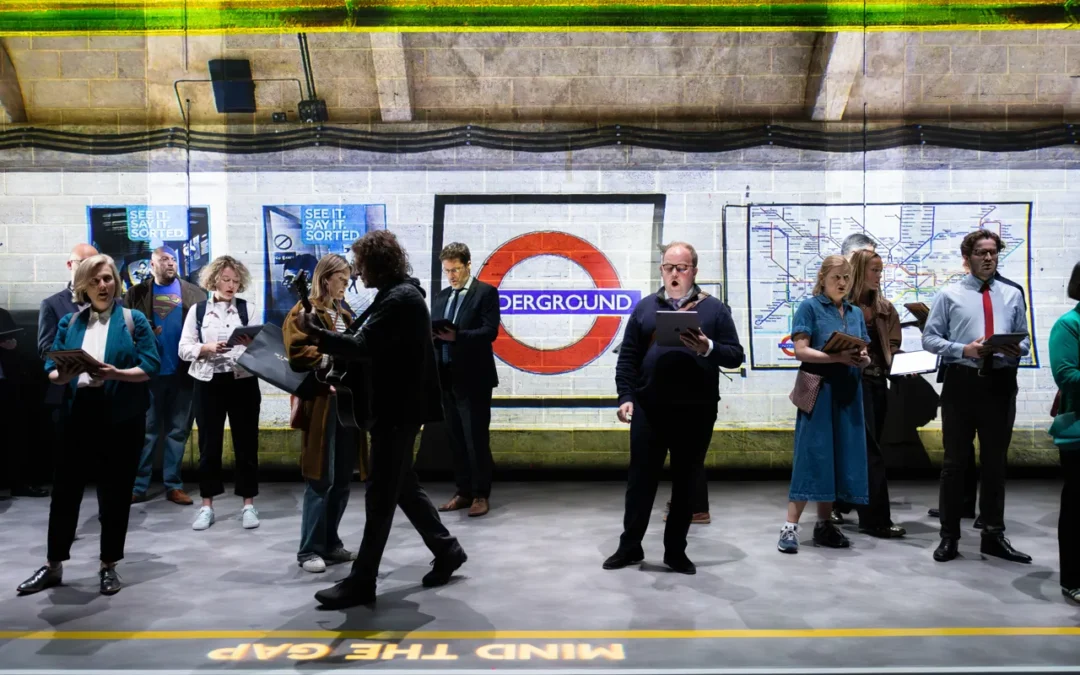 A still from Angels On The Underground showing commuters on the platform of a London Underground station