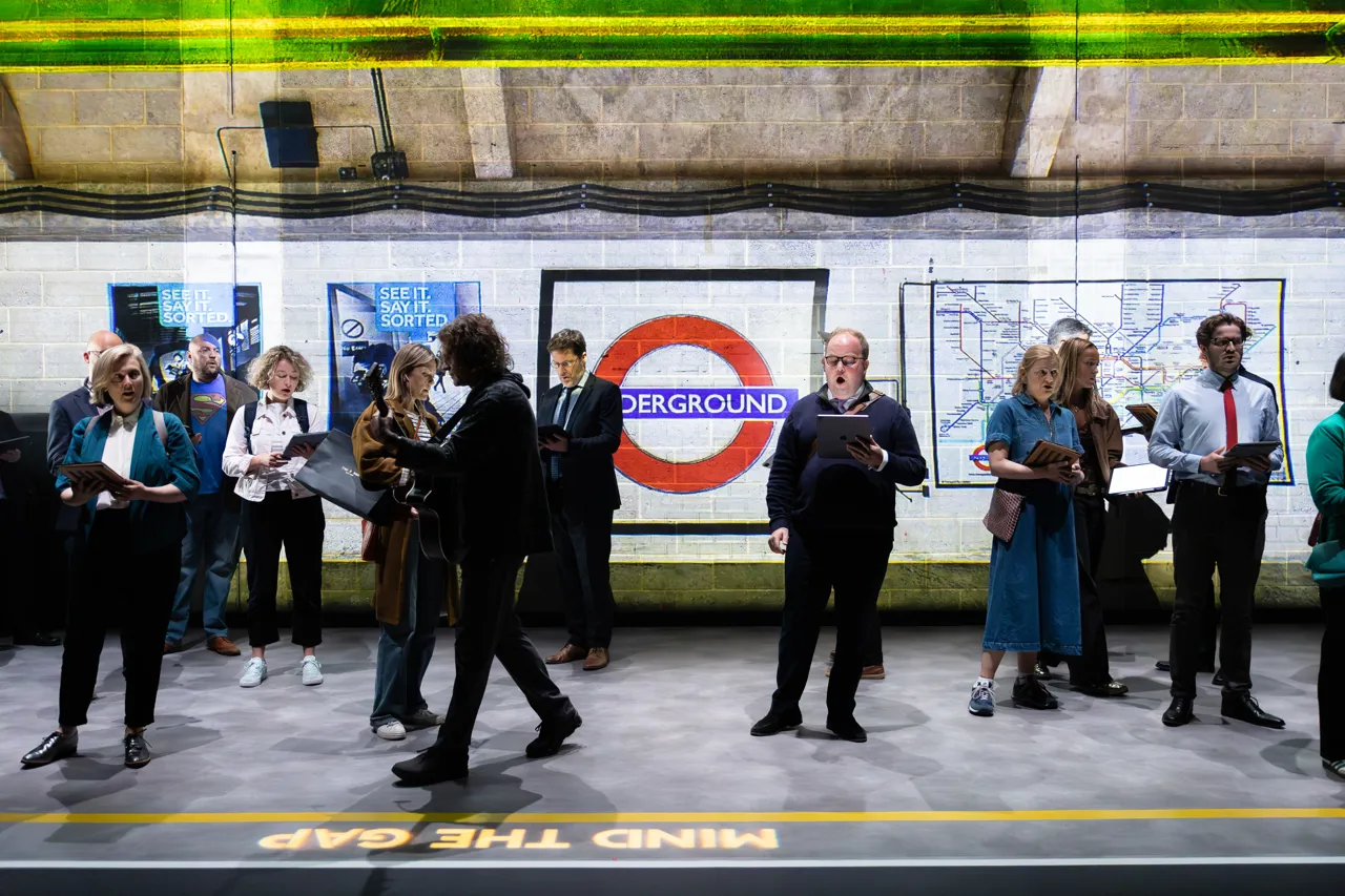A still from Angels On The Underground showing commuters on the platform of a London Underground station